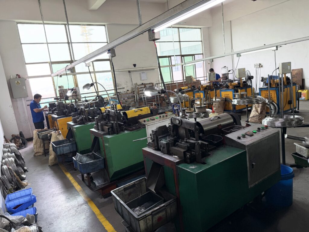 Semi-automatic flexible production line for hardware fasteners, workers operating precision forming machines 